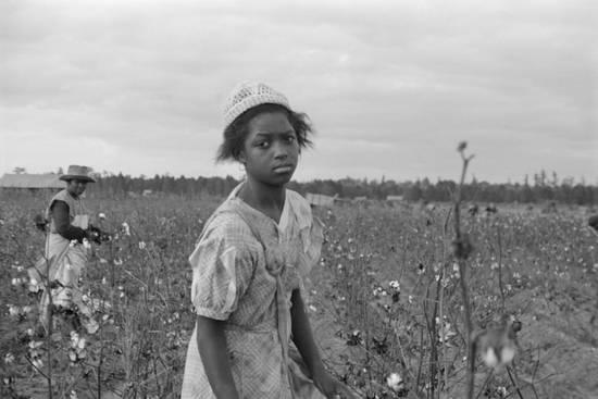 Black white photo of girl and boy in a field.